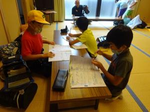 避難所でさっそく宿題を始める留学児童の写真